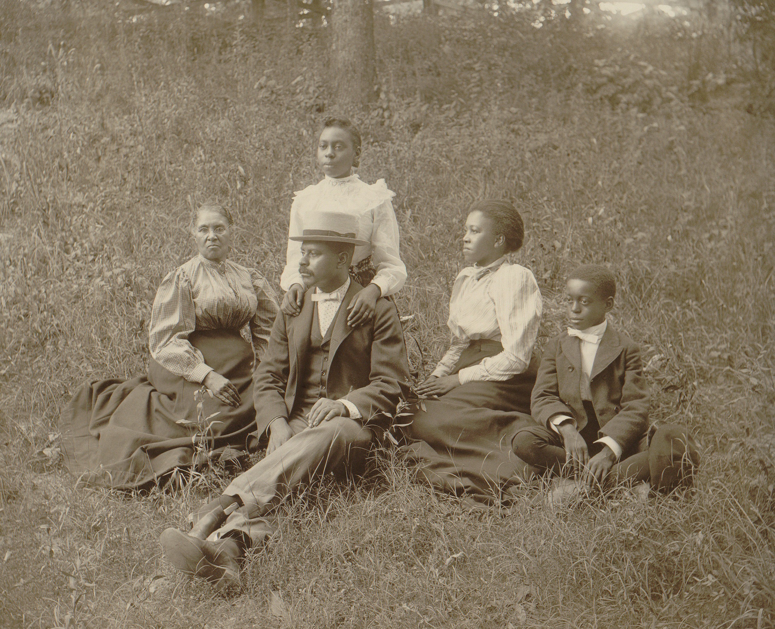 Middle class African American family seated on lawn in Georgia, ca